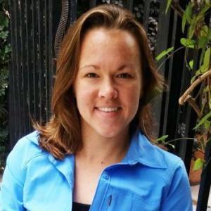 liz kirby pictured wearing a blue button up. 